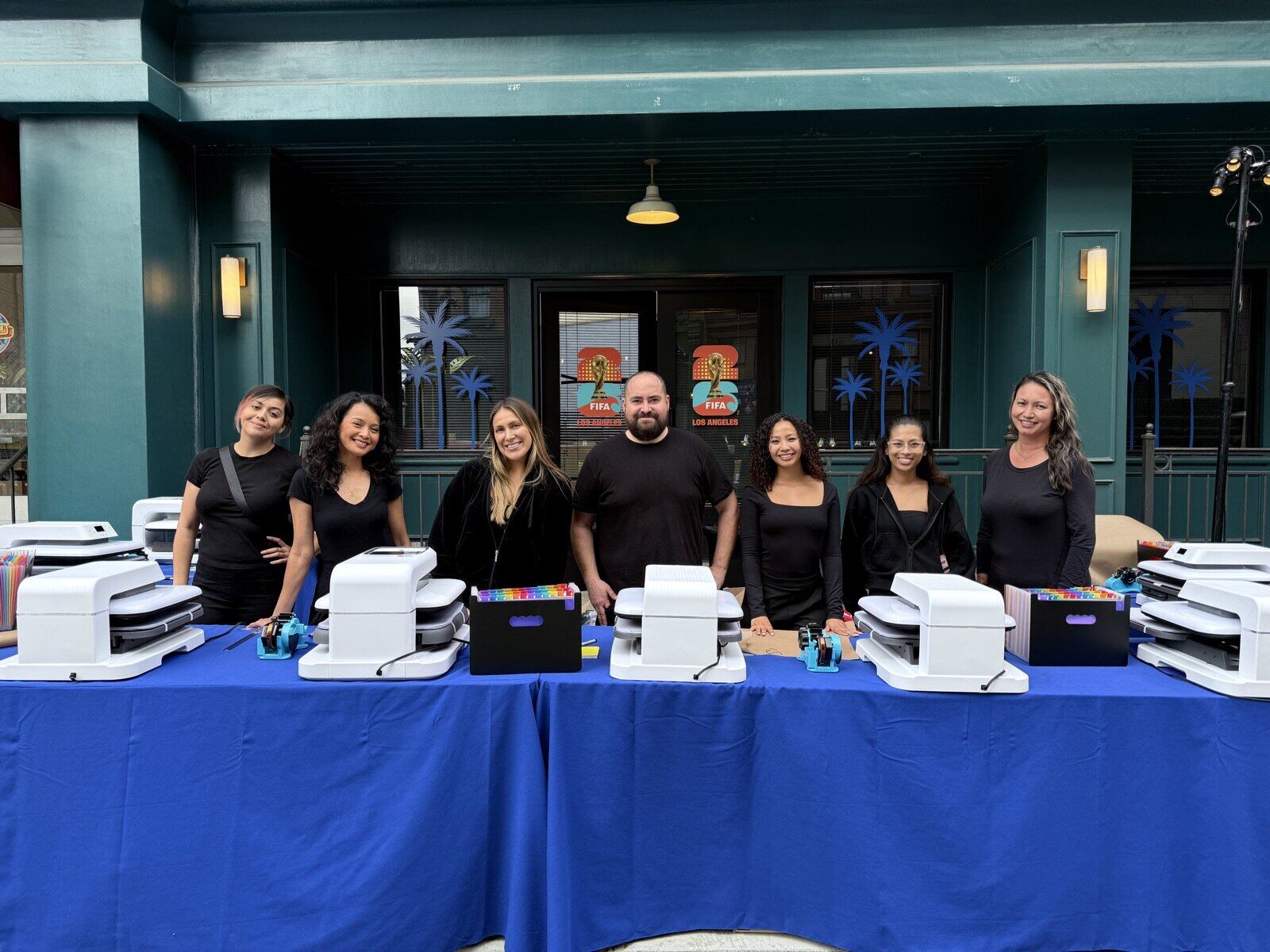 Full-color DTF graphic being pressed onto a white t-shirt at a Merch Troop live station