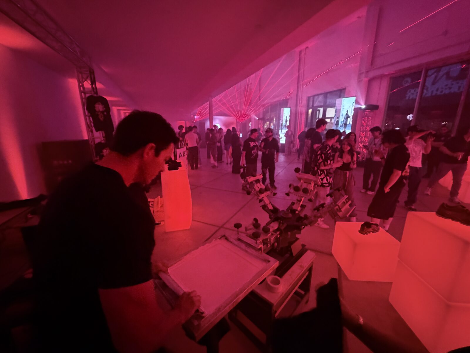 Nighttime party live printing station lit up on the event floor